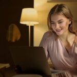 Free Woman in Pink Dress Shirt Using Laptop Computer Stock Photo